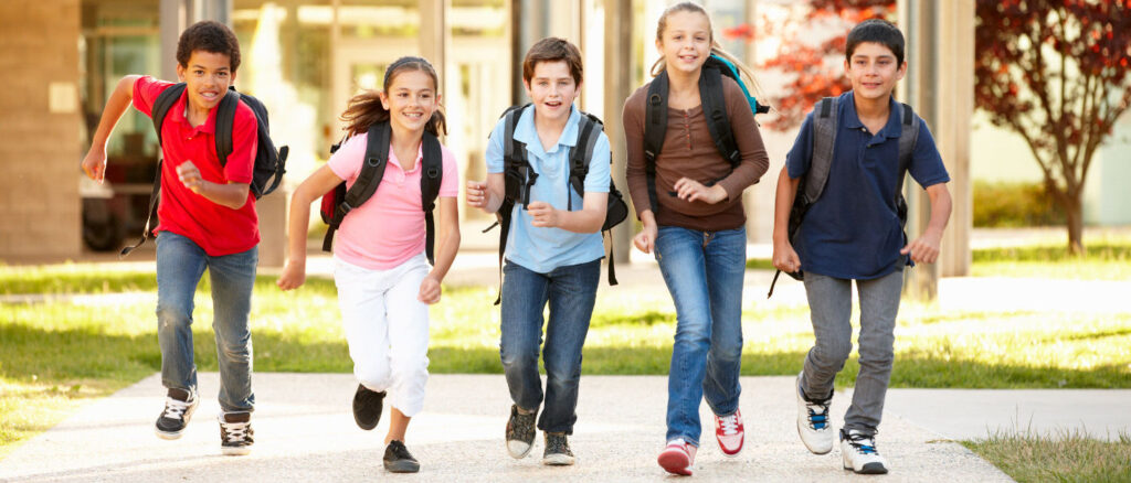 school kids running on the road