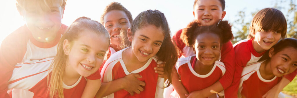 school kids with smiling face wearing sports uniform